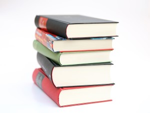 Photo of five books stacked in a pile